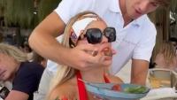 Braless Brooks Nader hand-fed by hunky waiter as star nearly spills out of low-cut red top on lavish Italian getaway