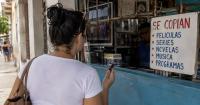 A Cuban woman requests a survival reality show to copy onto a USB, and the scene sparks laughter
