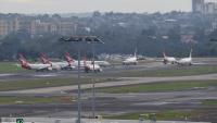 Sydney Airport delays of up to an hour hit travellers