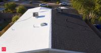 A reflective roof coating reduced peak roof temperature by 14.1°C and indoor temperature by 2.4°C; later research found evaporative cooling could add further benefits