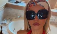 Baywatch star Brooks Nader wears plunging red swimsuit as she gets fed her dinner during lavish Italian yacht holiday