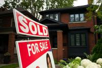 Higher mortgage rates will add more downward pressure on housing prices, economists say