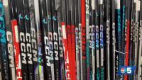 Local sports equipment stores owners say tariffs make it challenging to stock up on hockey sticks