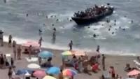 Shocking moment dozens of migrants storm beach packed with tourists near Spain’s La Manga resort loved by celebs