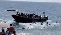 Tourists flee as migrants storm Spanish beach