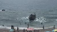 Unlawful migrants land boat on popular Spanish tourist beach