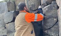 Tourists deface UK World Heritage Site by hammering 10,000 coins into its rocks - forcing officials into a 200-hour clean-up