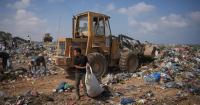 Palestinians in Gaza scavenge trash for things to burn to cook meals, in photos