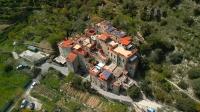 Italy's Once-Abandoned Medieval Town Is Now A Welcoming, Unique Eco-Village Nestled Between The Alps And The Sea