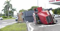 Truck transporting generator overturns