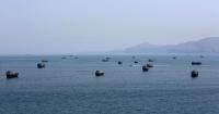 A ship is damaged by a projectile off the coast of Oman in the Strait of Hormuz.