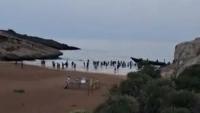 Moment dozens of cheering migrants charge onto Spanish beach after being dropped off by speedboat ‘taxi’