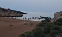 Moment dozens of cheering migrants charge up Spanish beach after being dropped off by speedboat 'taxi'