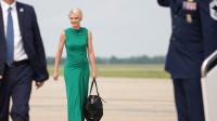 Grinning Natalie Harp struggles with massive bag as she joins Trump in Texas