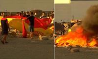 Moment Spanish flag-waving Ceuta locals storm and set makeshift migrant camp on fire - as minister calls for calm