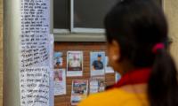 Families put up posters outside Kathmandu hospital in hope of finding their loved ones