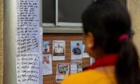 Families post photos outside Kathmandu hospital for missing kin