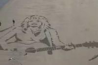 Dutch beach artist creates giant Dolly Parton tribute portrait in the sand