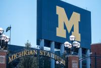 University of Michigan reaches settlement with woman who accused former football staffer of assault
