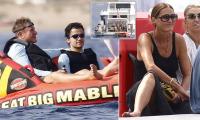 Duran Duran frontman Simon Le Bon, 67, clutches a beer on inflatable boat ride during family holiday with wife Yasmin on luxury yacht in Sardinia