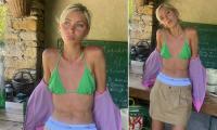 Iris Law shows off her toned figure in a skimpy green bikini as she gives a glimpse of her fun-filled summer