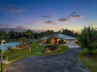 Live the SWFL lifestyle at this private, five-acre retreat