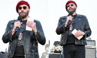 John Travolta rocks ANOTHER beret at Ramones 50th anniversary tribute... after fans mercilessly roasted his 'kooky' style