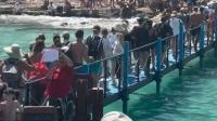 Tourist hotspot beach dubbed 'hell on earth' with two-hour queues and people 'unable to move'