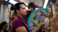 In a scorching Spain, the traditional folding hand fan is having a moment