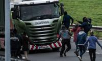 Sudanese migrant dies in failed attempt to leap onto the roof of a moving Britain-bound lorry from the top of a Calais road toll booth