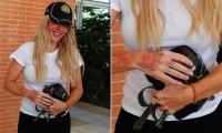 Ellie Goulding debuts new red ink hand tattoo as she keeps it casual in white T-shirt and Balenciaga baseball cap while touching down in Venice ahead of the 83rd Film Festival