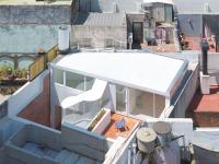 A Translucent Exterior Stair Reorganizes This 1950s “Propiedad Horizontal” in Buenos Aires
