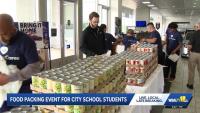 Baltimore volunteers pack 8,000 bags of food for students