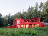 This cherry-red villa in the Czech forest refuses to blend in