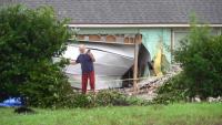 Woman hospitalized after medical emergency leads to crash into Cypresswood home