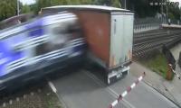Truck is smashed to pieces by speeding passenger train after driver gets HGV stuck on Polish rail crossing