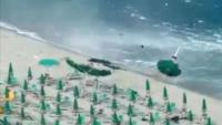Moment towering waterspout tornado slams into beach in Italy sending parasols flying into air as panicked tourists flee
