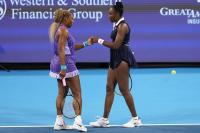 Williams sisters reunite their iconic doubles team, losing narrowly but thrilling the New York crowd