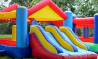 Two children on inflatable jumping castle are rushed to hospital after strong winds lifted it into the air
