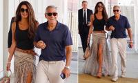 Amal Clooney wows in £1,695 snake print Elie Saab skirt as she links arms with husband George Clooney as they leave the 83rd Venice Film Festival
