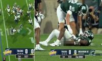 Humiliating moment college football star is caught with his pants down on live TV after opponent's bruising tackle