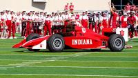 Indiana's Hoosier the Bison wheels around the field in an IndyCar for season opener