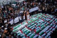 Palestinians in Gaza bury remains of 100 people
