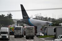 Amazon cargo plane overruns runway, collides with vehicles and catches fire