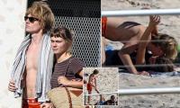 Bec and Lleyton Hewitt's 'nepo baby' daughter Mia puts on a VERY handsy display with her rocker boyfriend on Bondi Beach