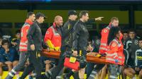 Borussia Dortmund star, 18, rushed to hospital after being carried off in Champions League game