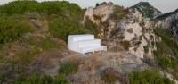 four-level white platform stands as a collective throne at the western edge of greece