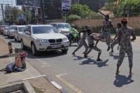 Street acrobats entertain motorists stuck in Kenyan capital’s notorious traffic