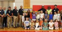 Power plant construction crews donate clothing to schools