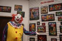 Artist dressed like a clown showcasing art about current state of the world